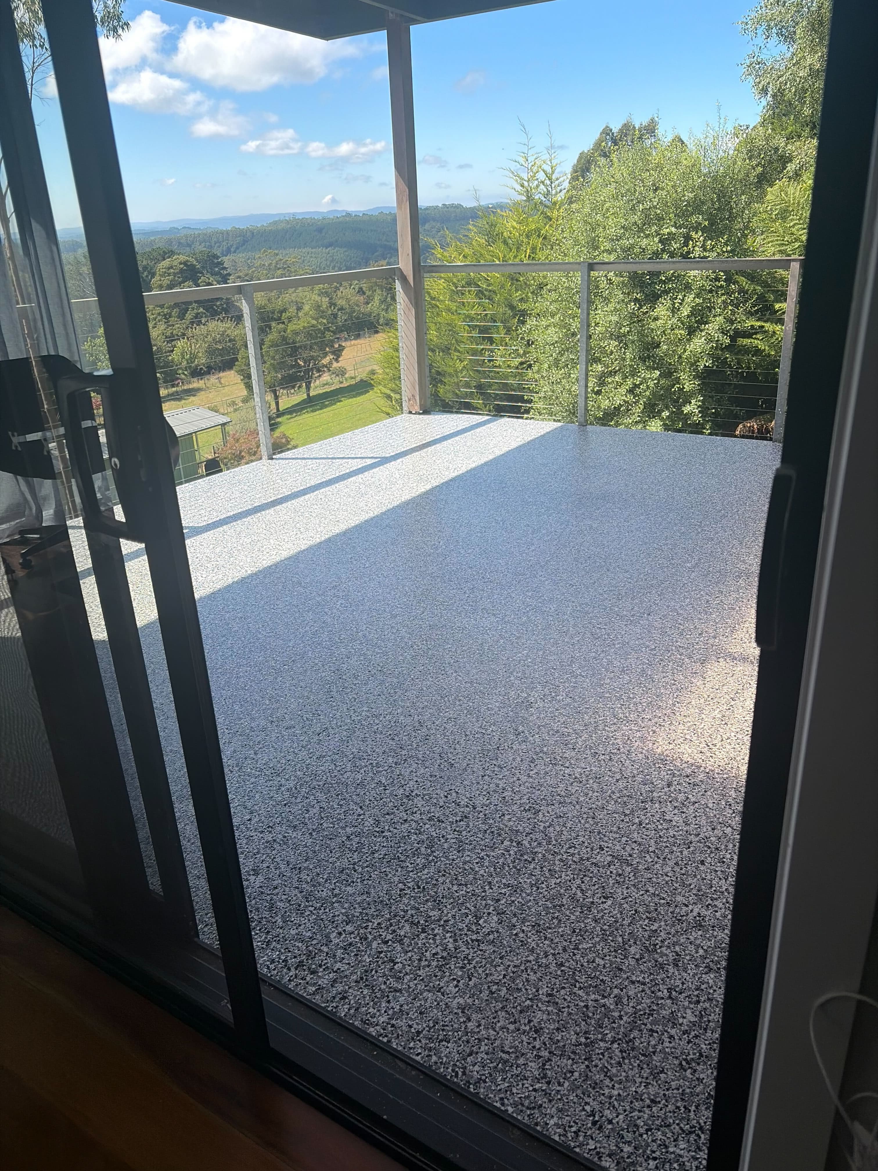 Outdoor alfresco with white flake epoxy and scenic view