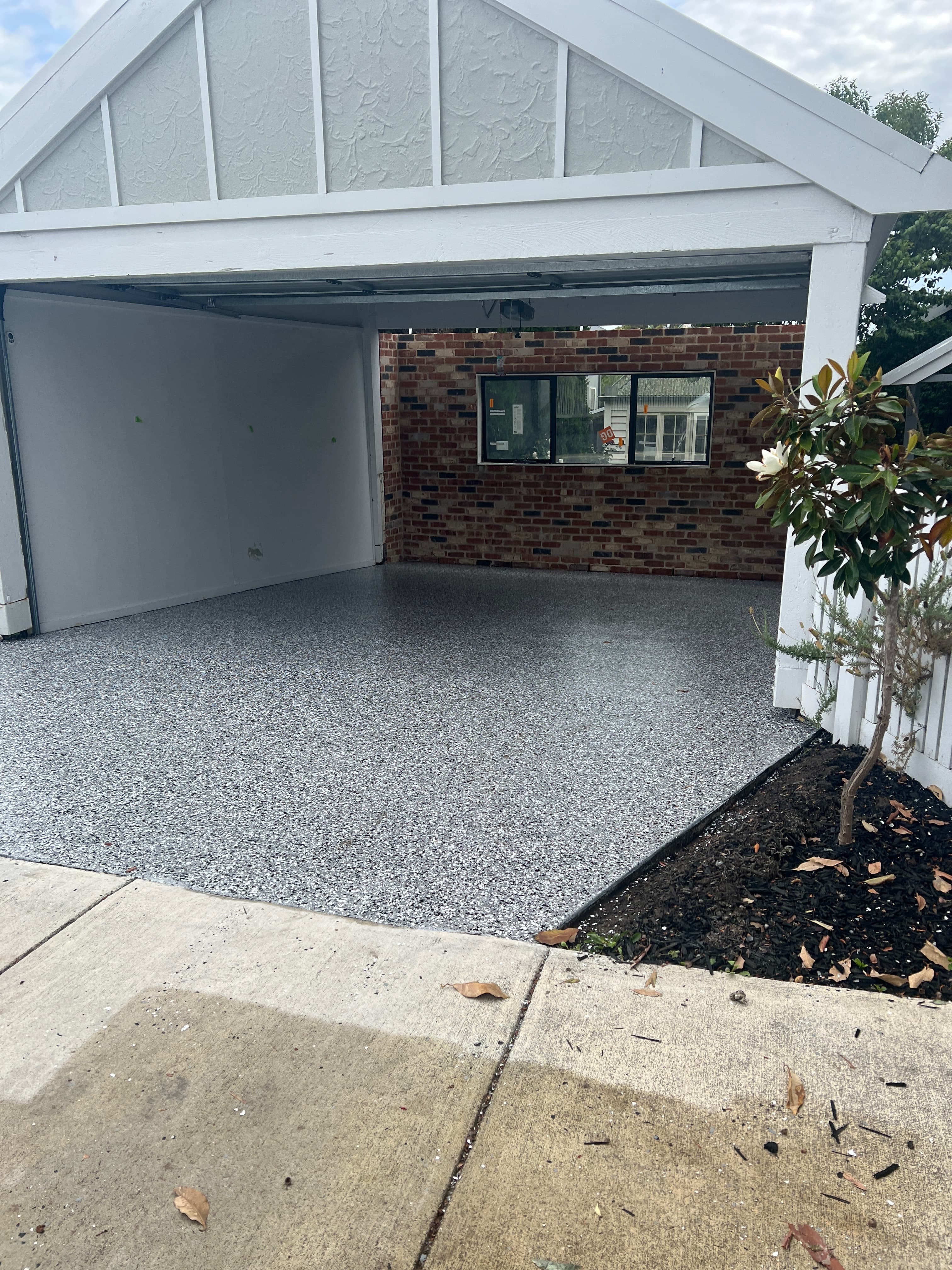 Residential carport with light grey flake epoxy