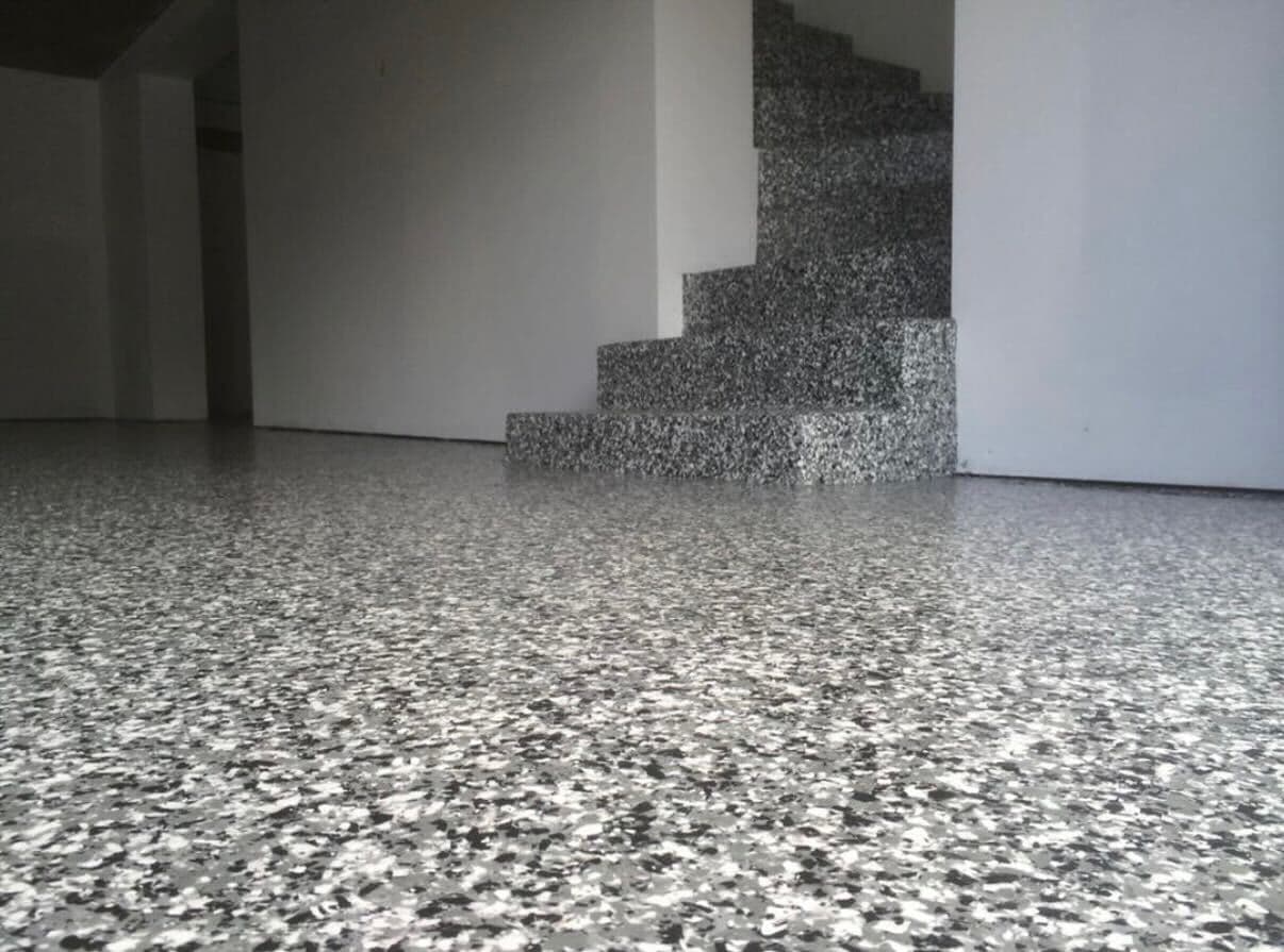 Residential staircase landing with grey flake epoxy